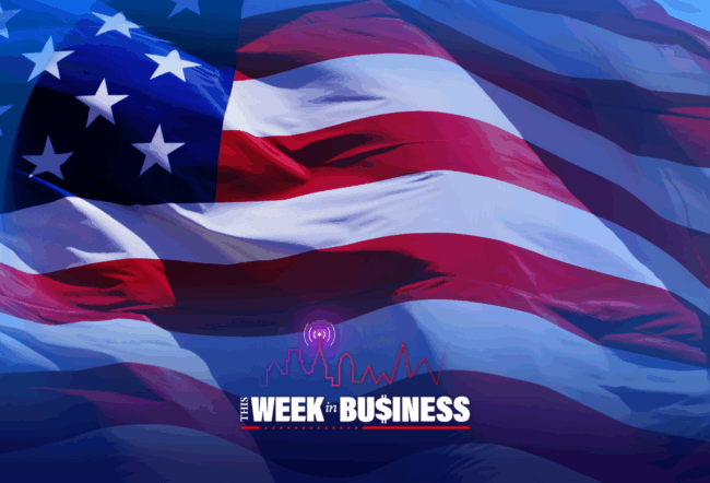 An American flag with "This Week in Business" text and a city skyline graphic in the foreground.